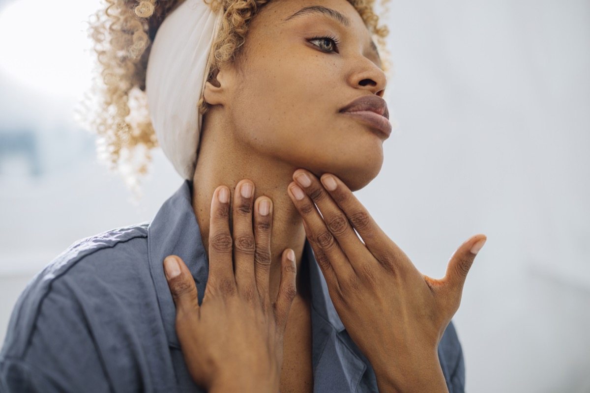 a woman who rubs her skin in the mirror