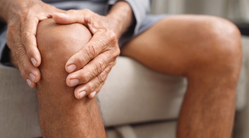 a man with swelling holding his knee